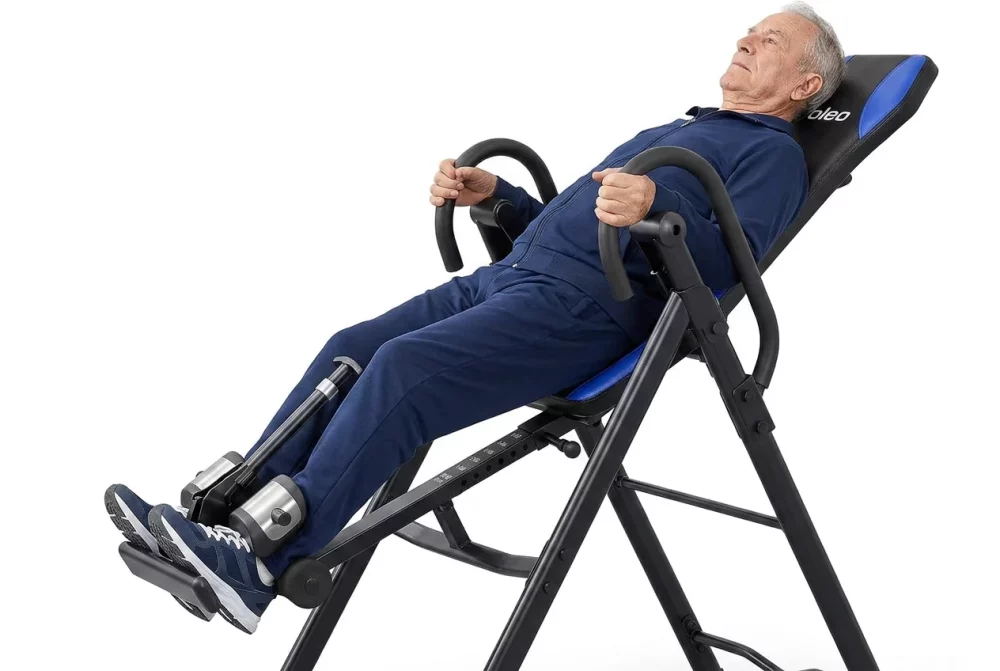 Elderly man using an inversion table for back relief